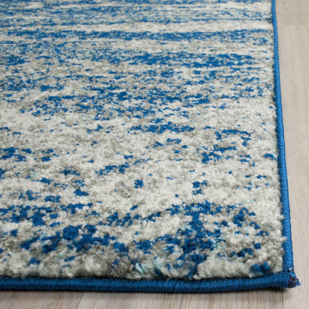 Soft navy and ivory pile meets crisp blue binding for a neatly finished edge.