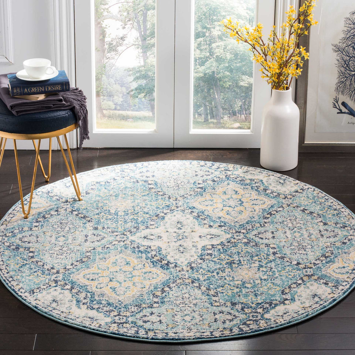 A round light blue and ivory rug brings vintage-inspired charm to a bright room with dark wood floors