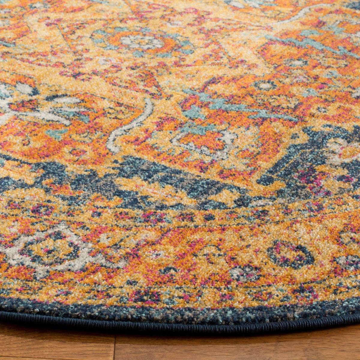 Distressed orange and blue scrollwork meets the neatly bound edge of this patterned rug