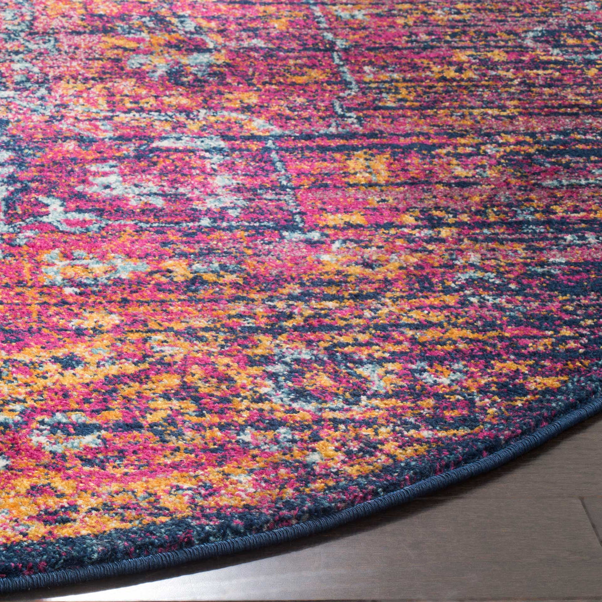 Dense fuchsia, blue and gold patterning meets a neatly bound navy edge