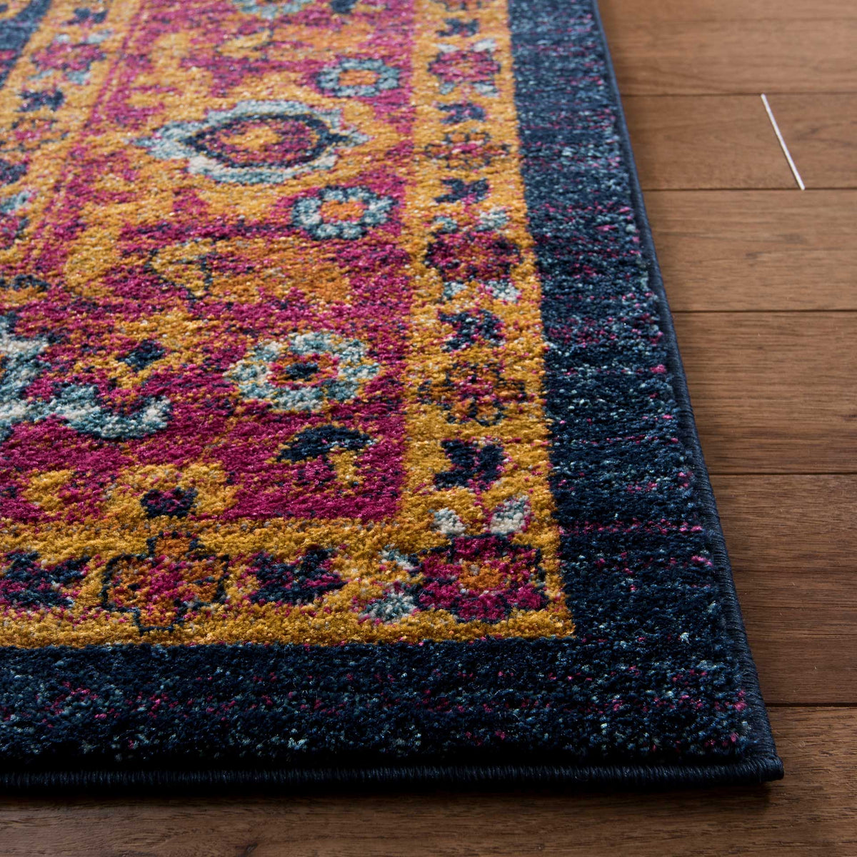 Bold fuchsia and orange flourishes meet a deep navy border and a crisp bound edge.