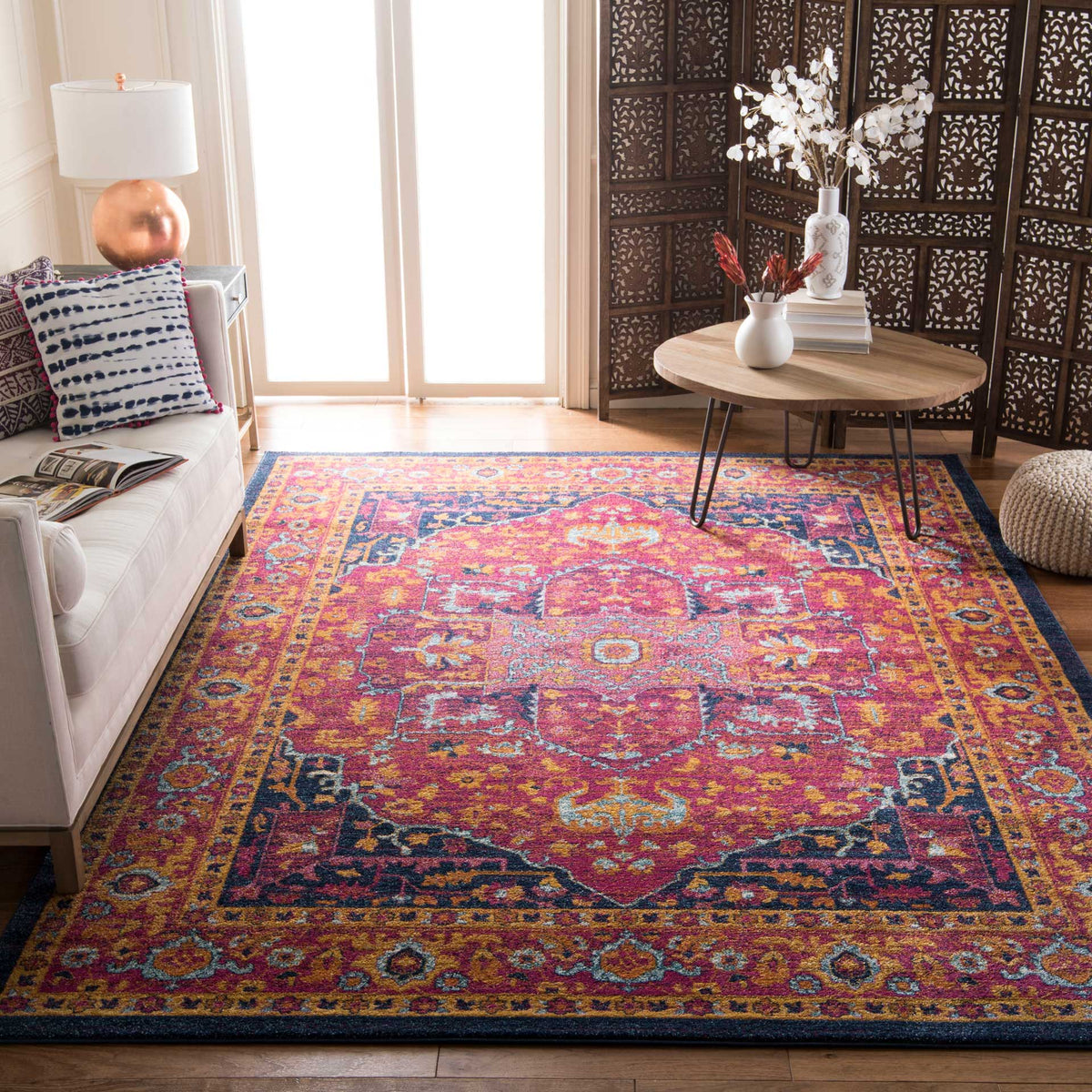 An elaborate fuchsia and orange design adds warmth beneath neutral living room furnishings.
