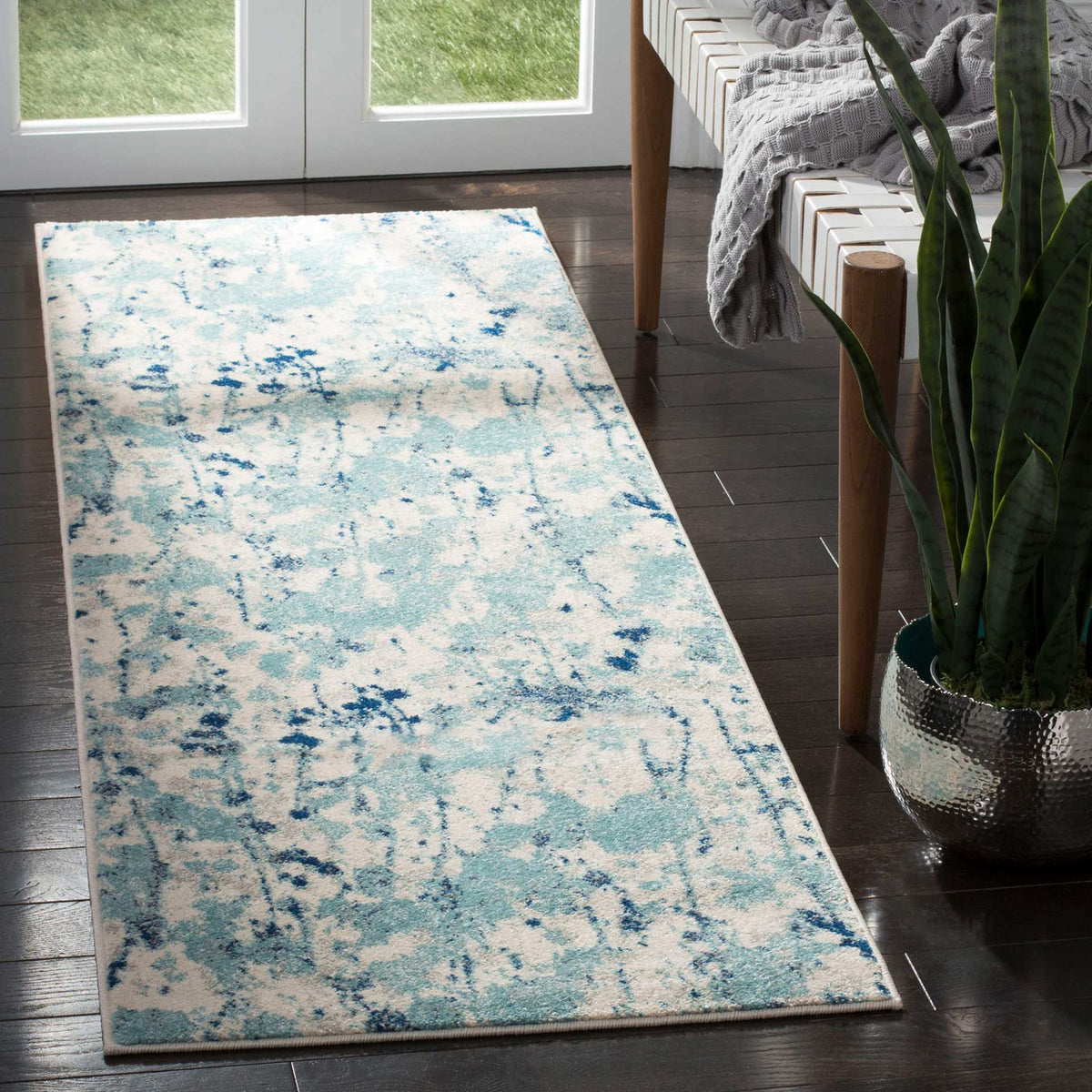 Soft ivory and blue abstract runner brings cool color to a dark wood floor
