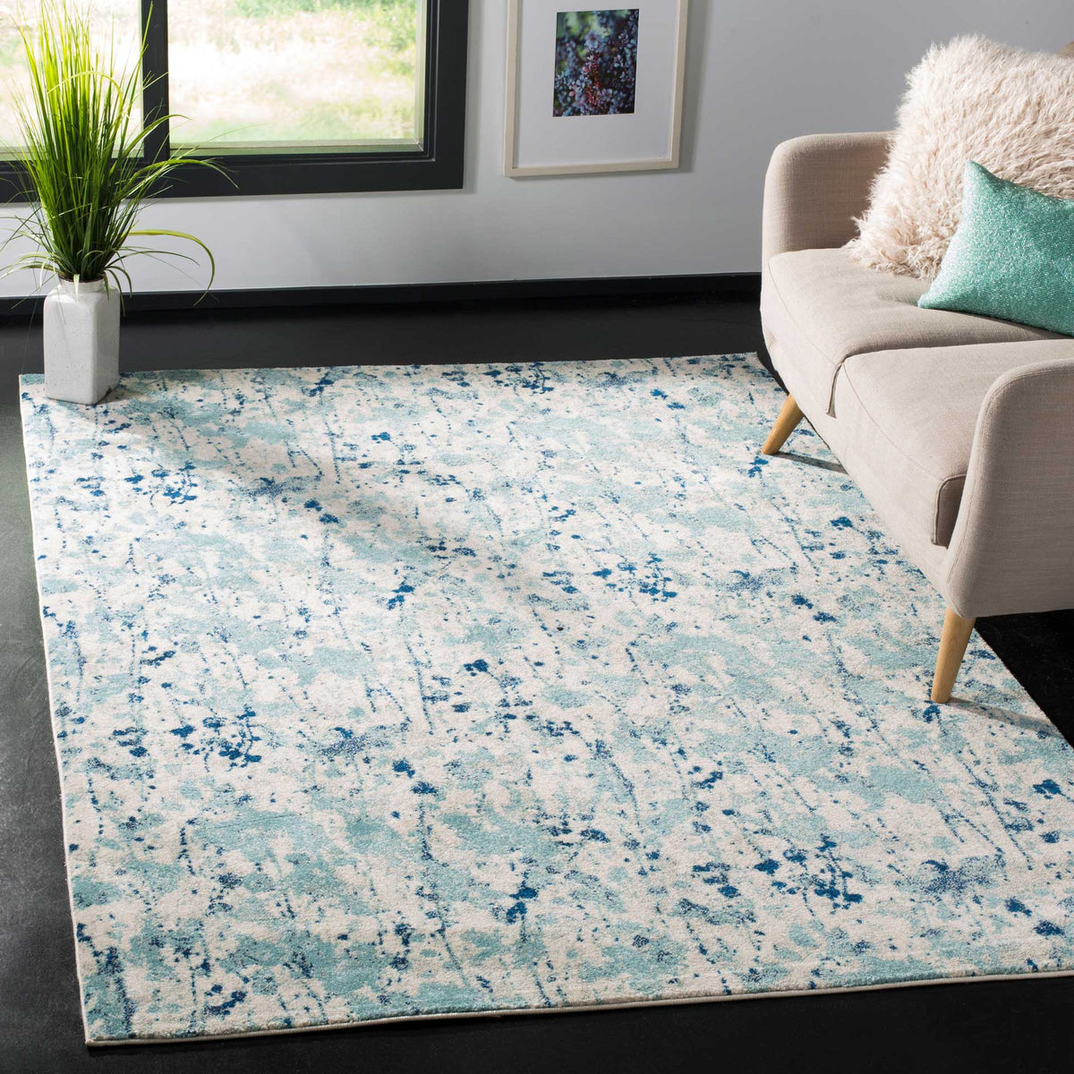 Cool blue and ivory abstract rug brings an airy touch beneath a cozy sofa