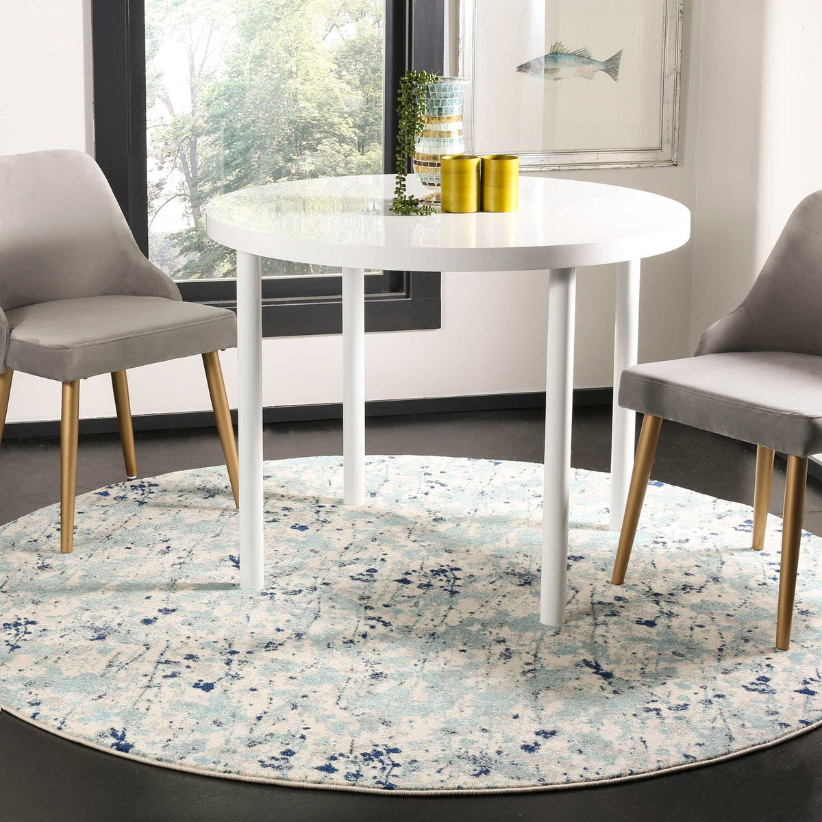 Ivory and blue round rug grounds a dining area with a softly distressed design