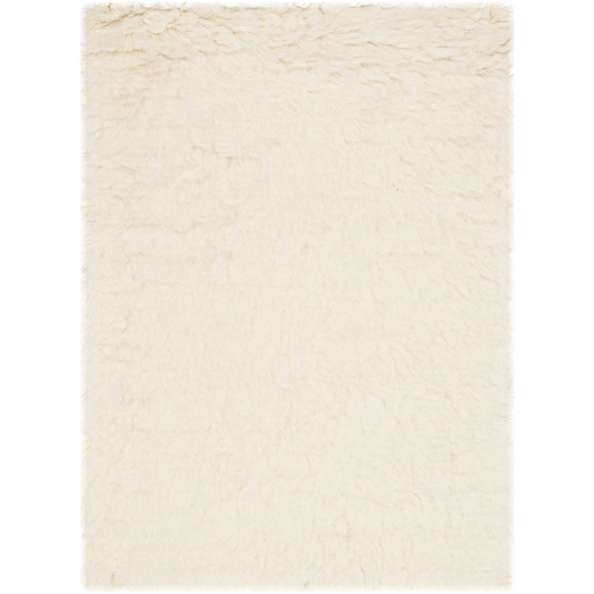 A small ivory accent rug brings welcoming wool softness to snug spaces