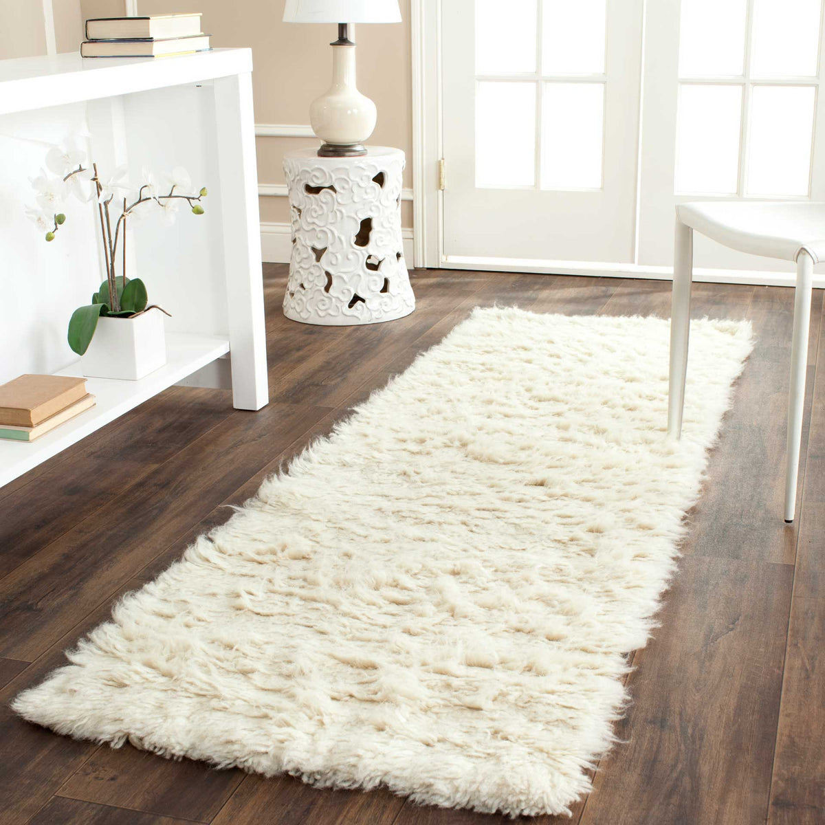 Plush ivory runner adds cozy wool texture and warmth to a wood-floor space