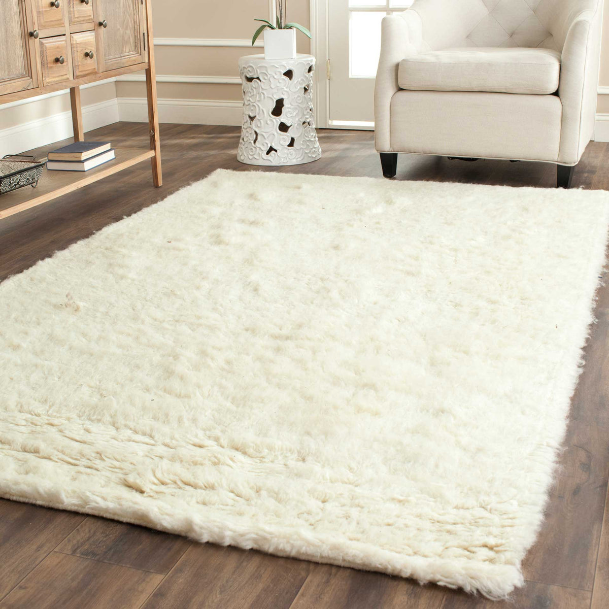 A thick ivory shag rug brings a cozy feel to warm wood floors and a bright seating area