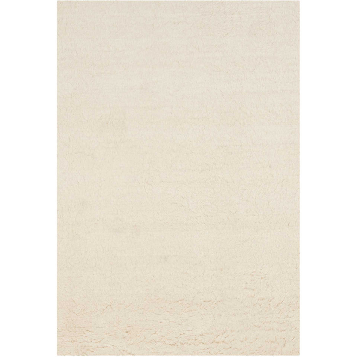 A rectangular ivory wool rug lends gentle warmth with its soft, shaggy surface