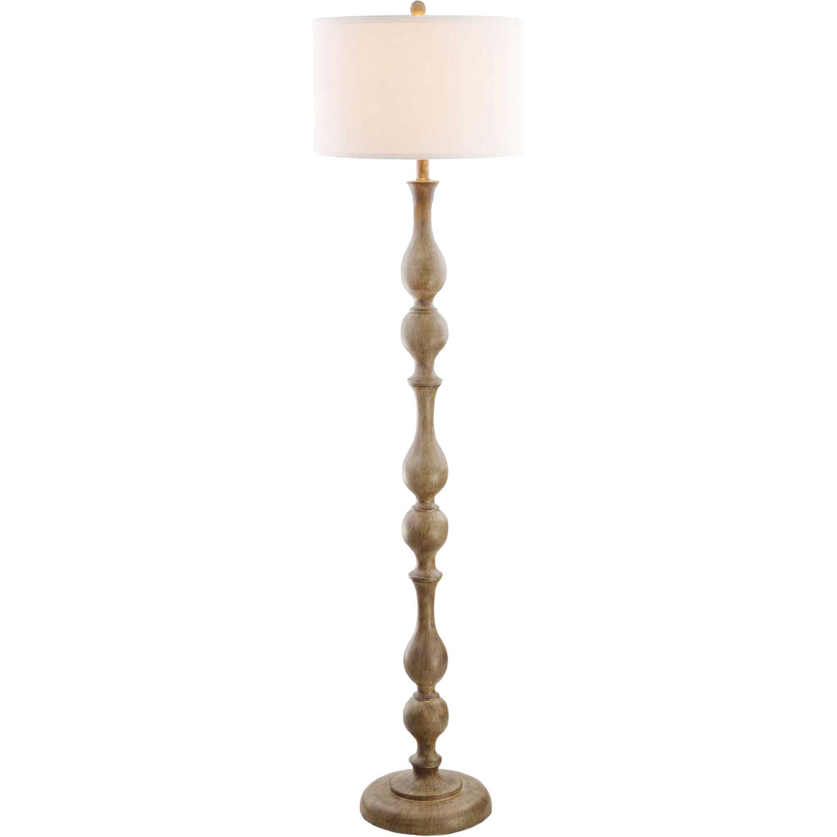 Warm light glows through the drum shade above a slender, sculpted brown base