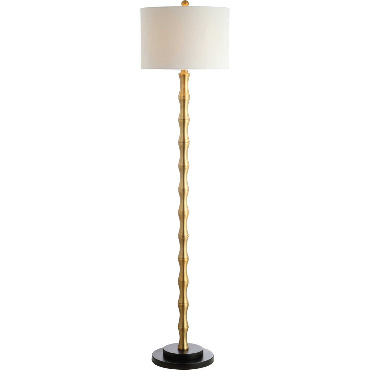 An off-white drum shade glows softly above a bamboo-inspired gold stem