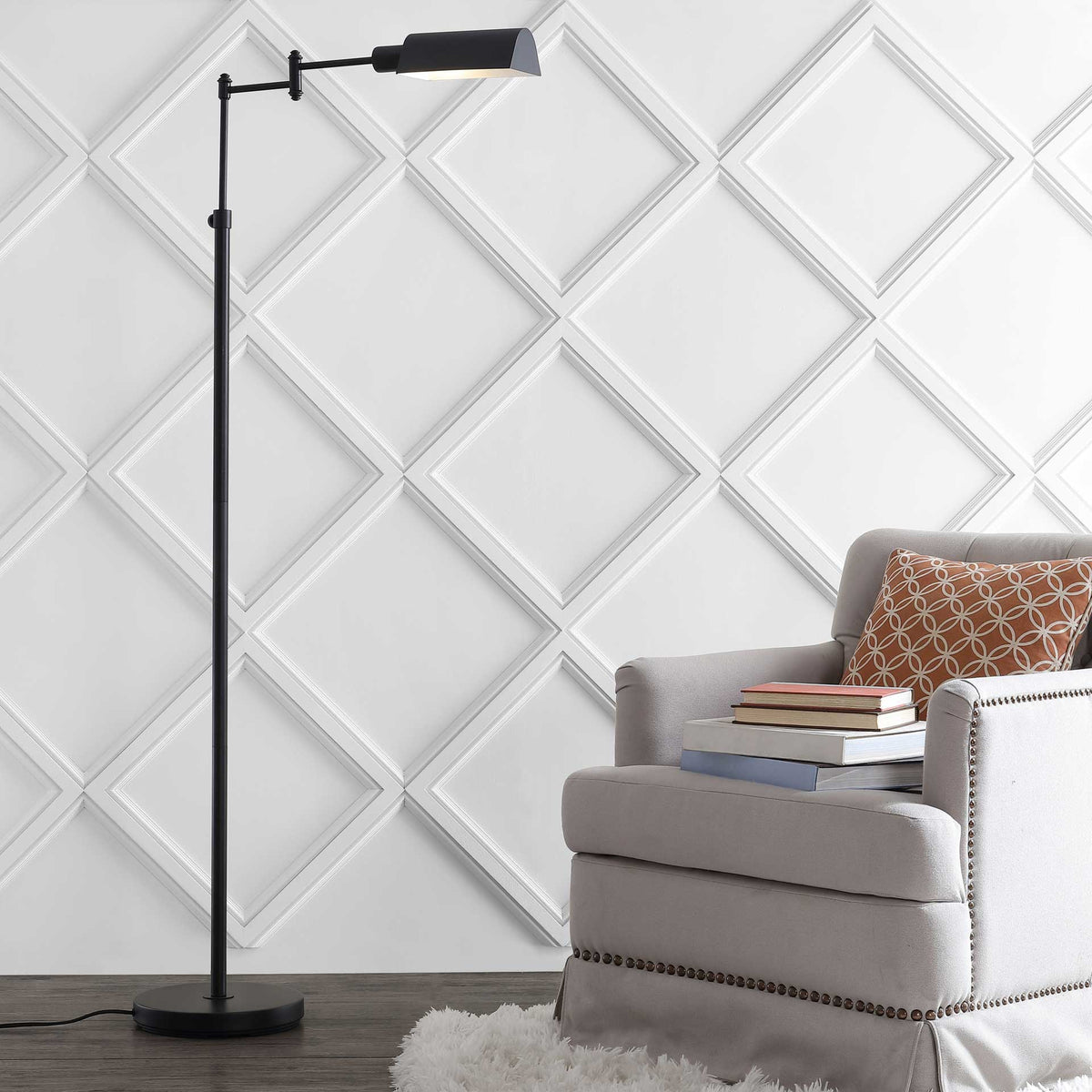 Slim bronze floor lamp adds a warm downlight beside a cushioned armchair