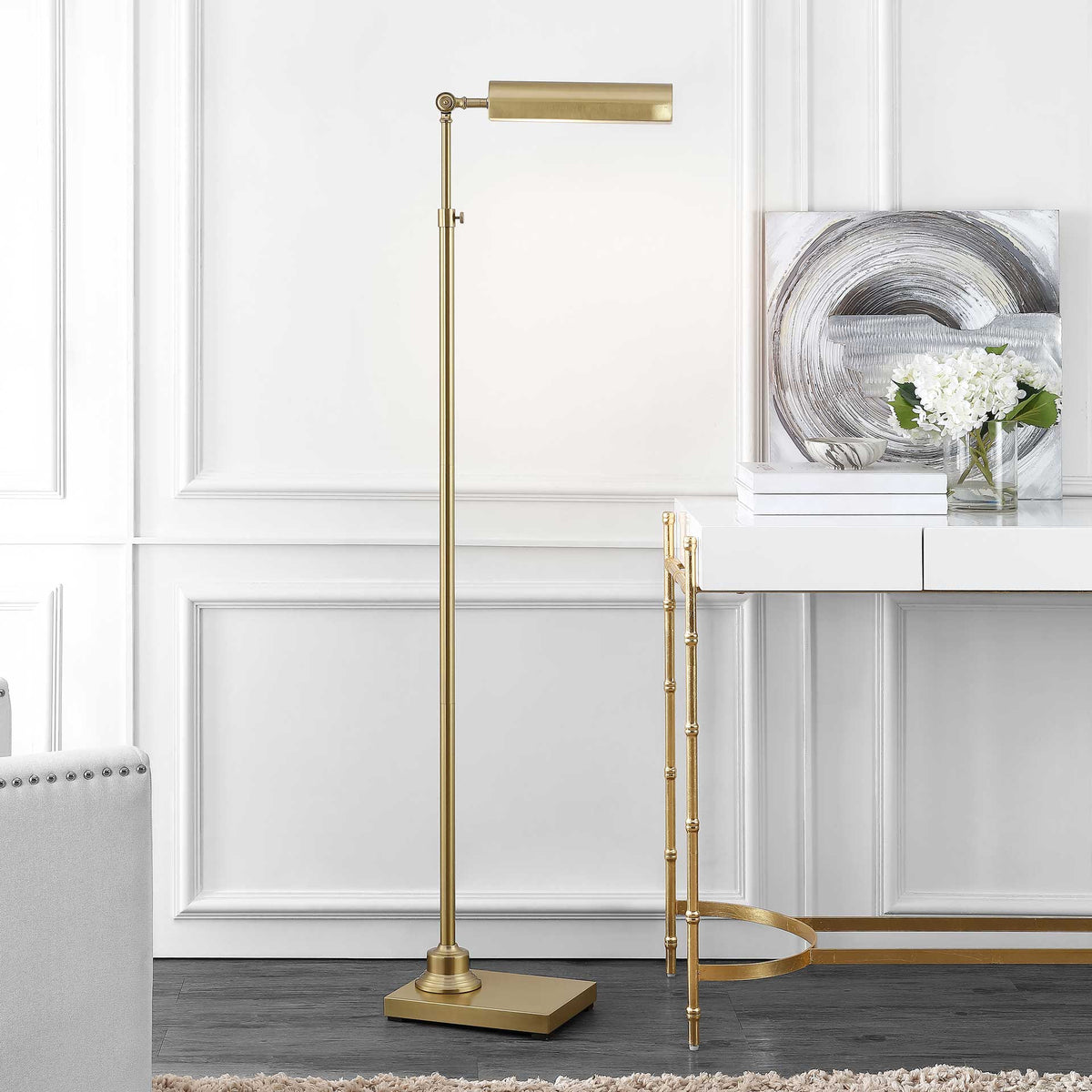 An adjustable brass floor lamp lends a soft, focused glow to a modern living space.