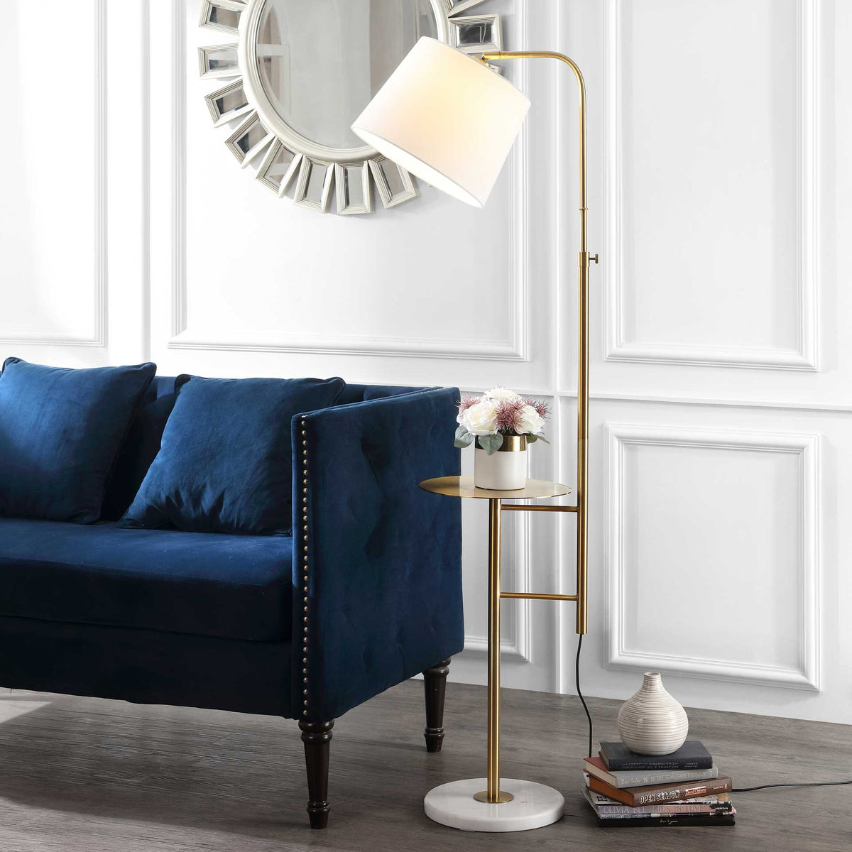 An illuminated off-white shade casts a warm glow over the gold floor lamp's built-in table