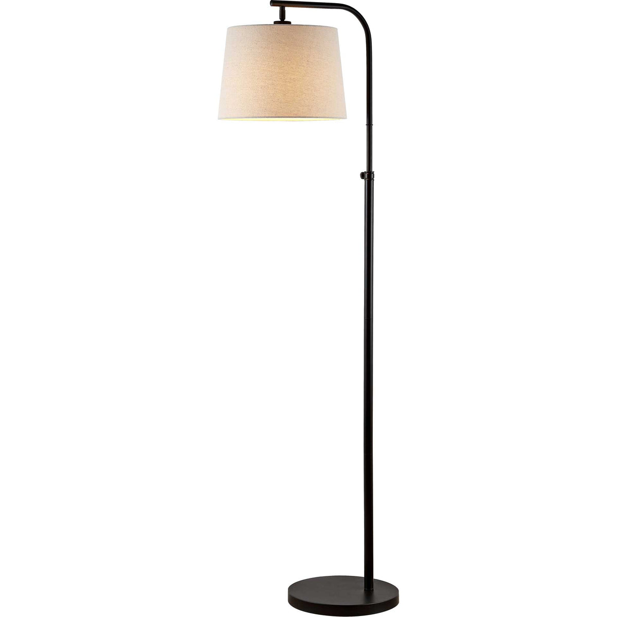 A softly glowing fabric shade casts warm light above a slim bronze-finished stand and round base