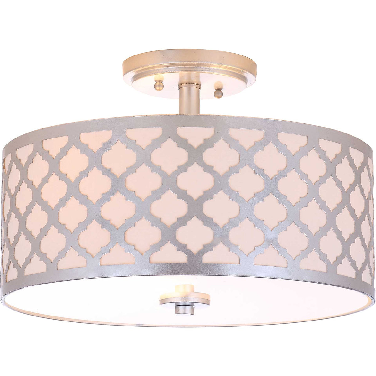 A softly lit drum shade reveals its silver quatrefoil overlay and white lower diffuser