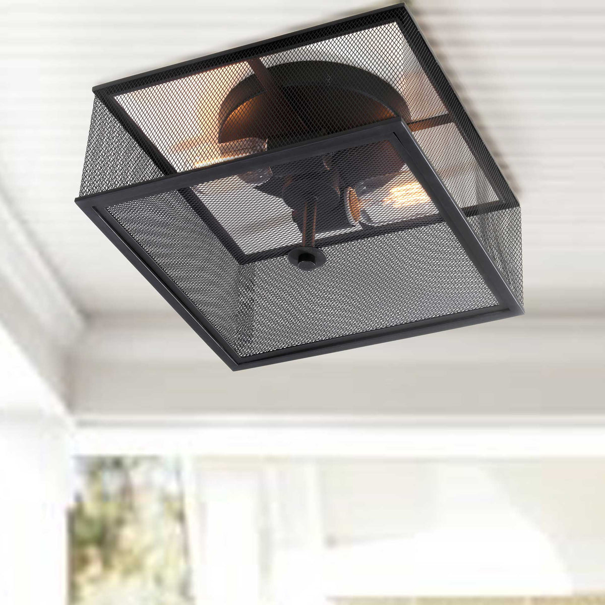 Warm light shines through a black iron mesh ceiling fixture with a sleek square frame