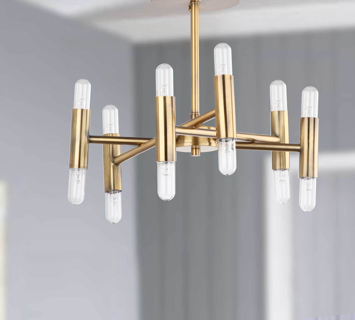 Staggered gold arms support vertical metal sockets and clear bulbs