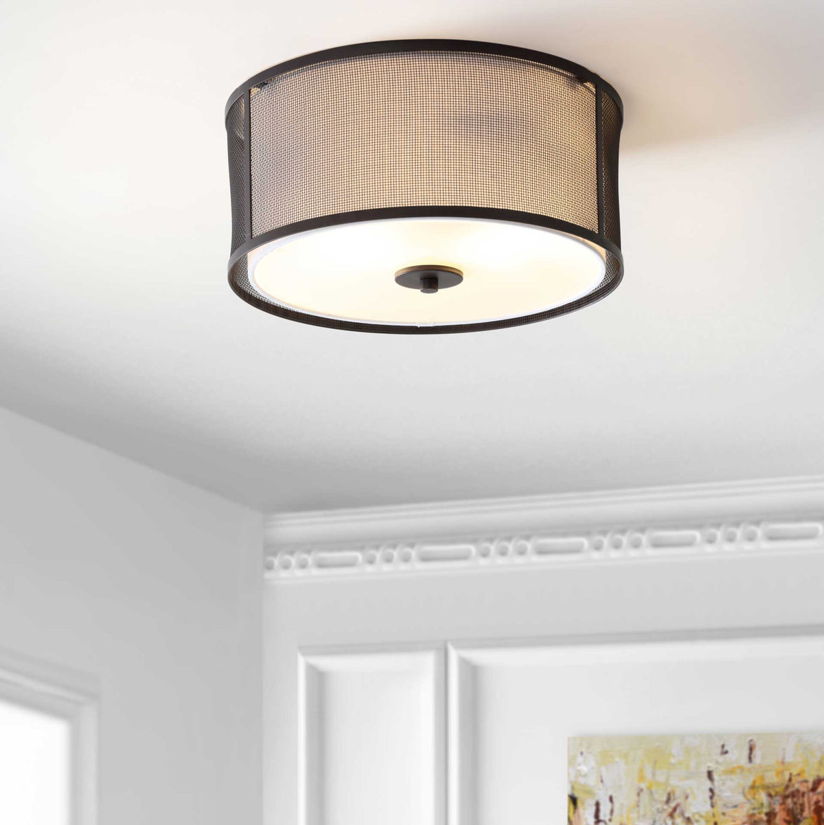 A warm glow shines through the dark mesh shade for inviting illumination.