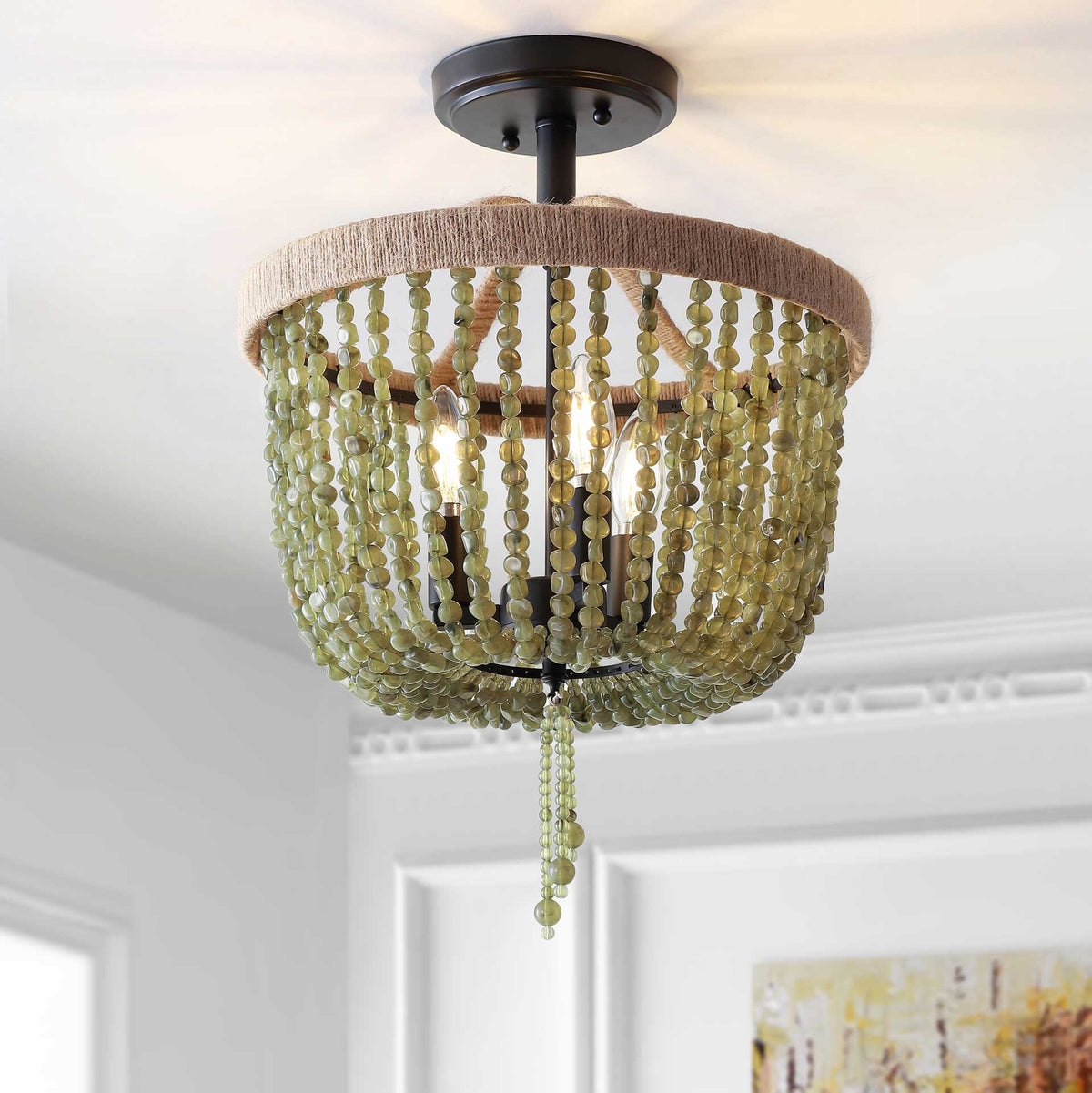 Warm light glows through green stone bead strands, casting a soft pattern across the ceiling.