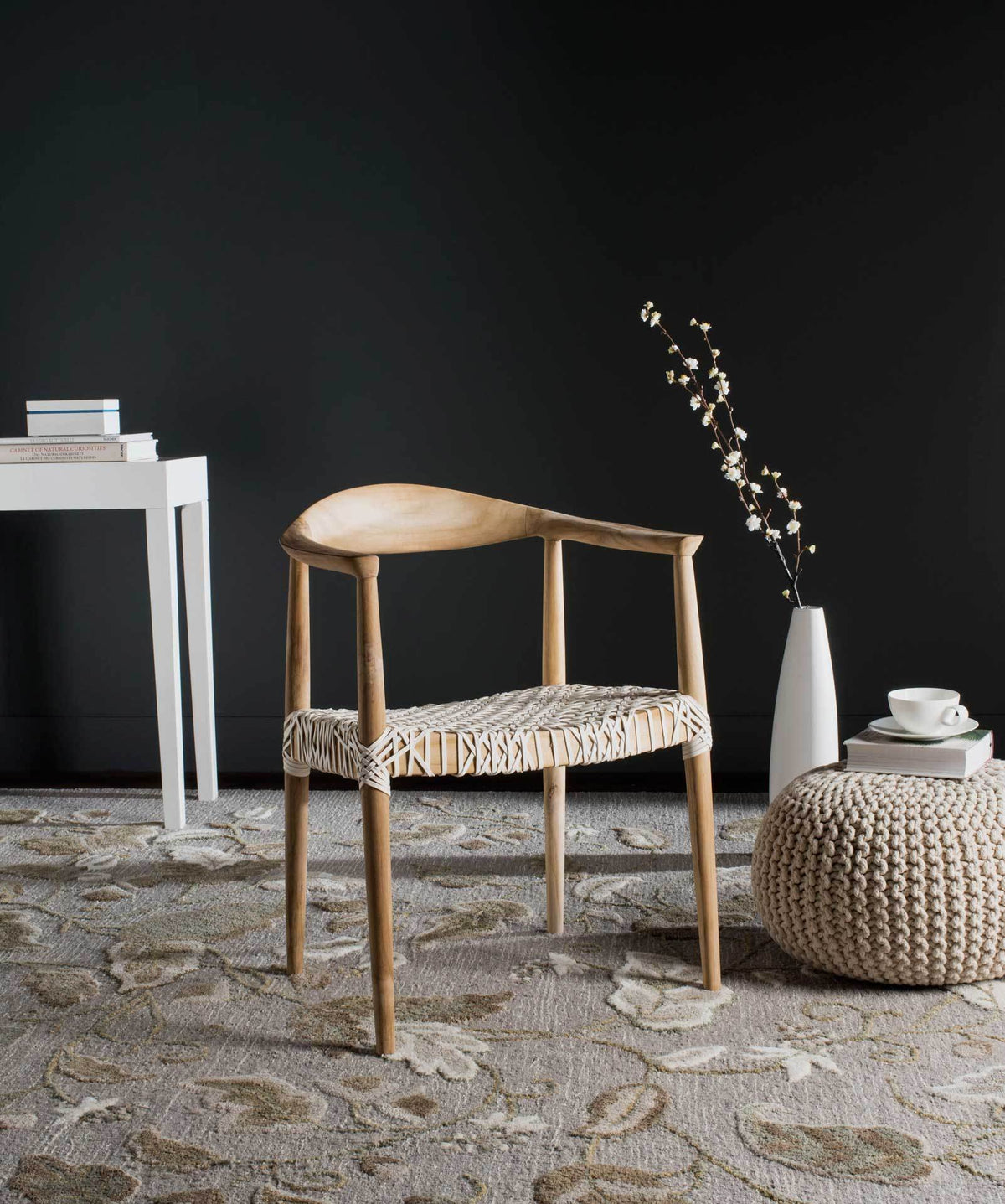 Light oak-finished teak and an off-white woven seat bring natural texture to a cozy living space.