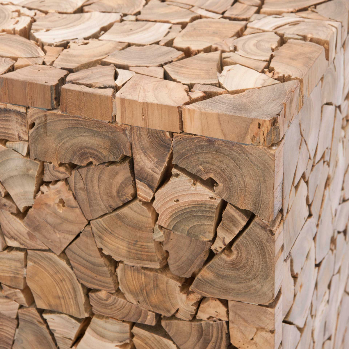 Natural grain and growth rings enrich the teak mosaic across the stool's top and sides.