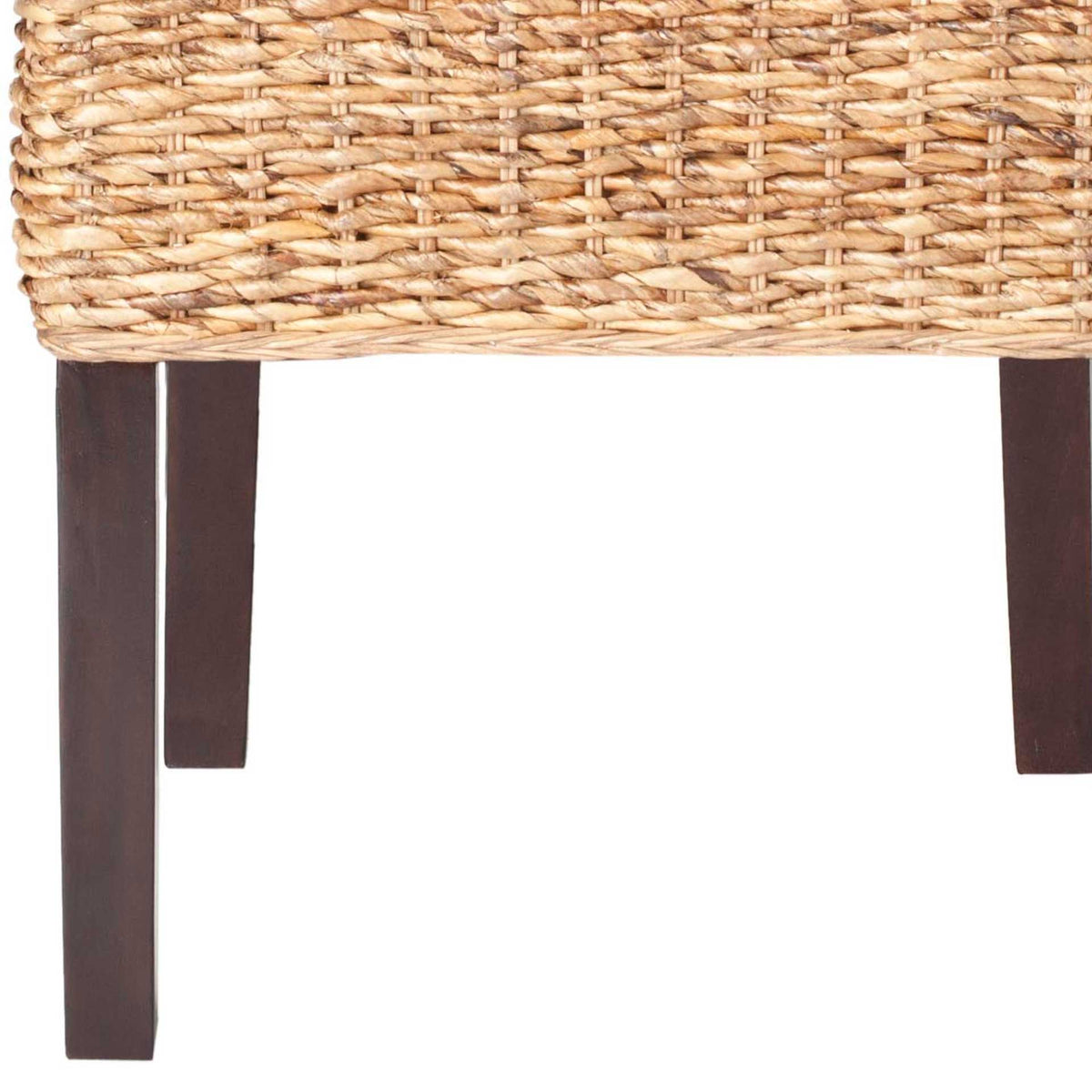 Slim dark wood legs contrast with the tightly woven rattan seat.
