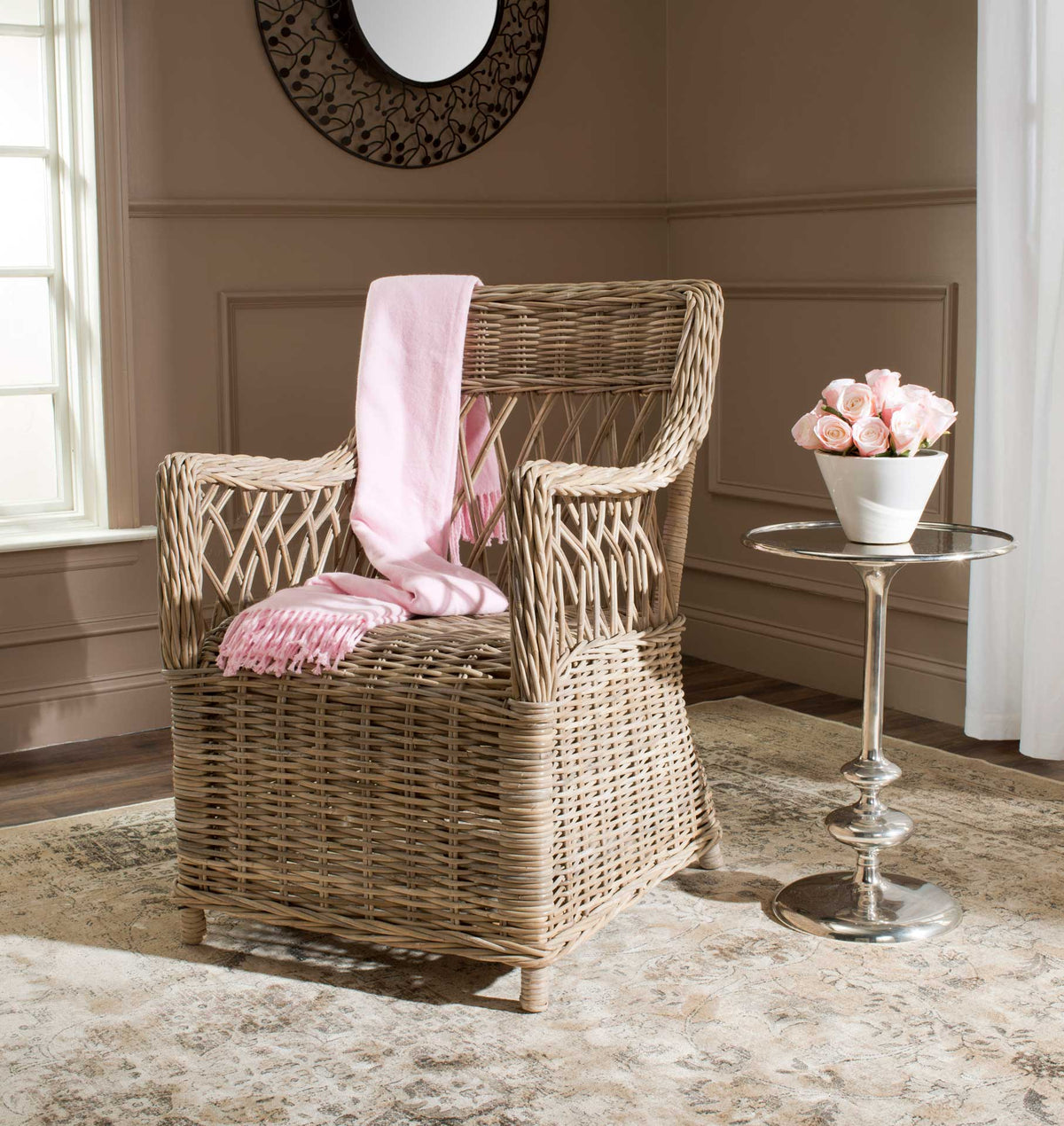Natural rattan armchair adds open-weave texture and relaxed warmth to a cozy living space