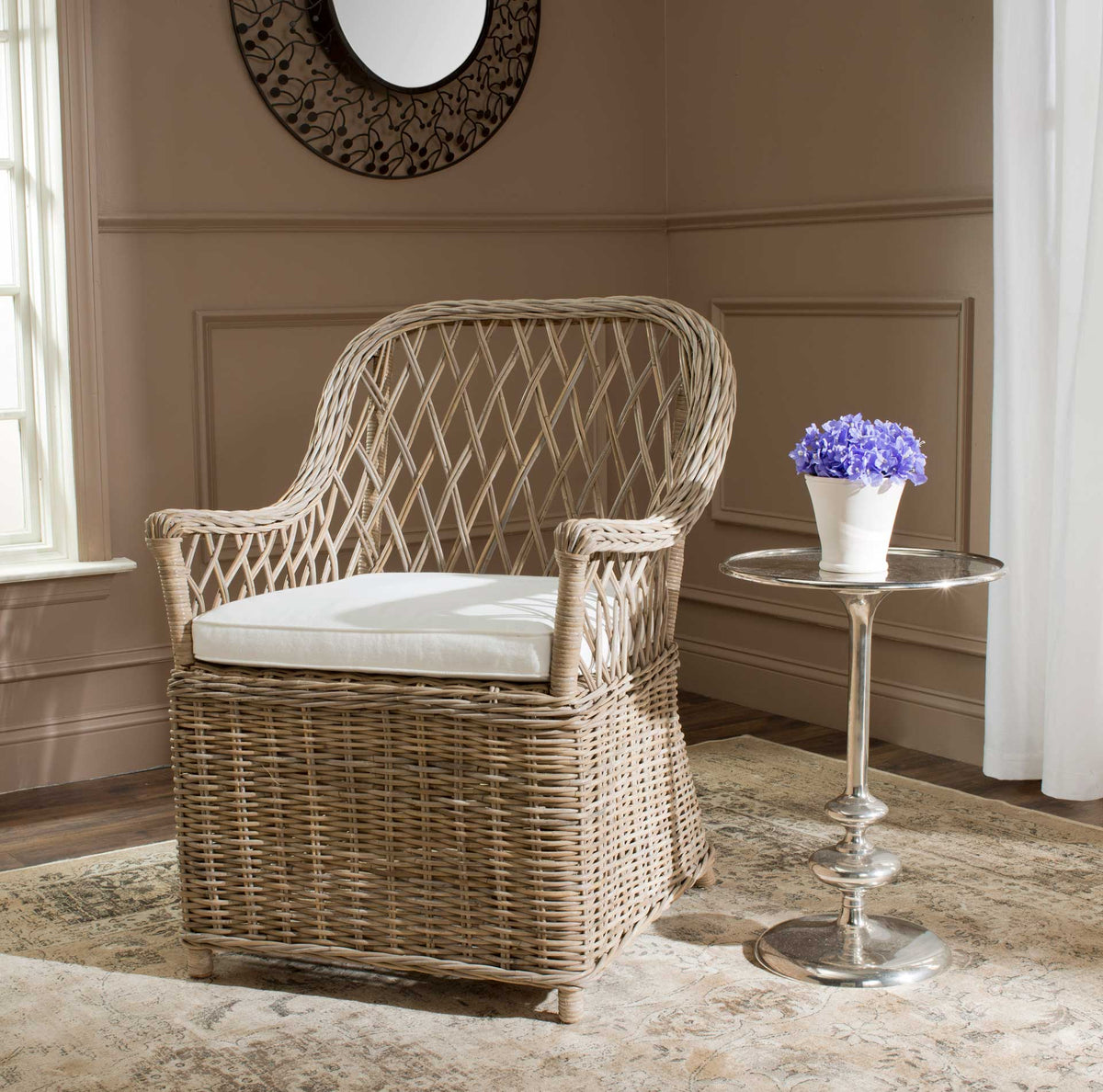 Natural rattan armchair with a sweeping lattice back and white cushion adds warmth to a living space