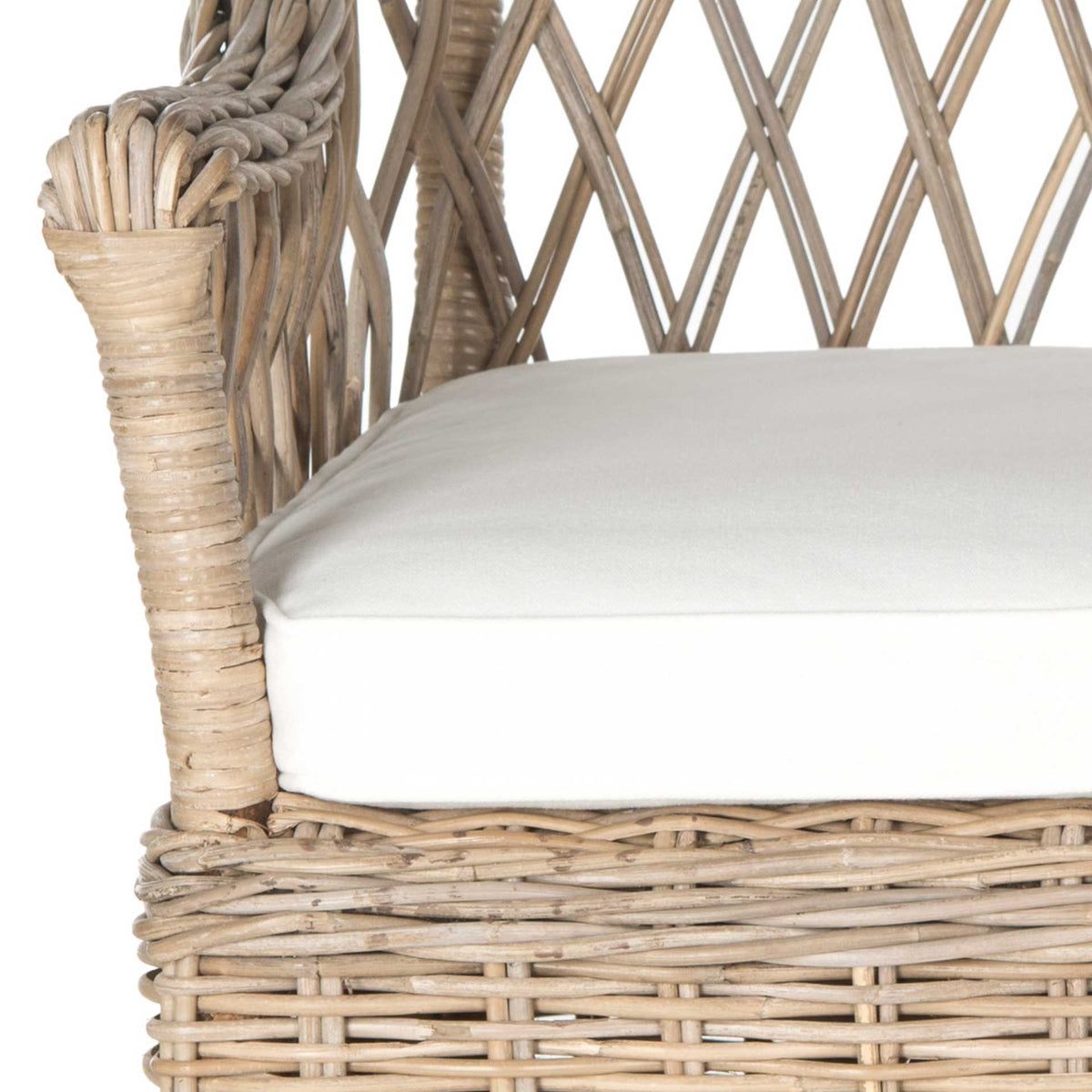 Wrapped rattan arm supports and woven textures complement a thick white seat cushion