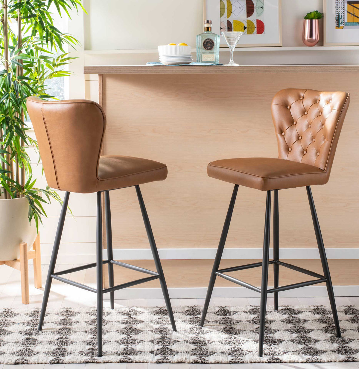 Two camel bar stools pair a smooth outer back with diamond-tufted upholstery at a home bar.