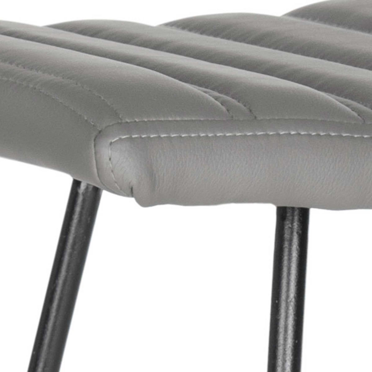 Textured gray faux leather and even channel stitching finish the generously padded seat.