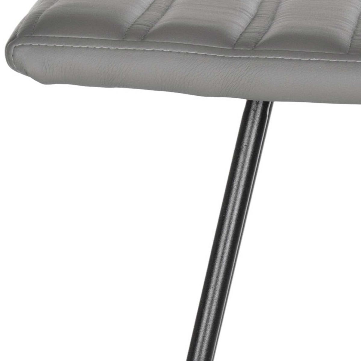 A sleek black leg rises to meet the softly rounded edge of the gray upholstered seat.