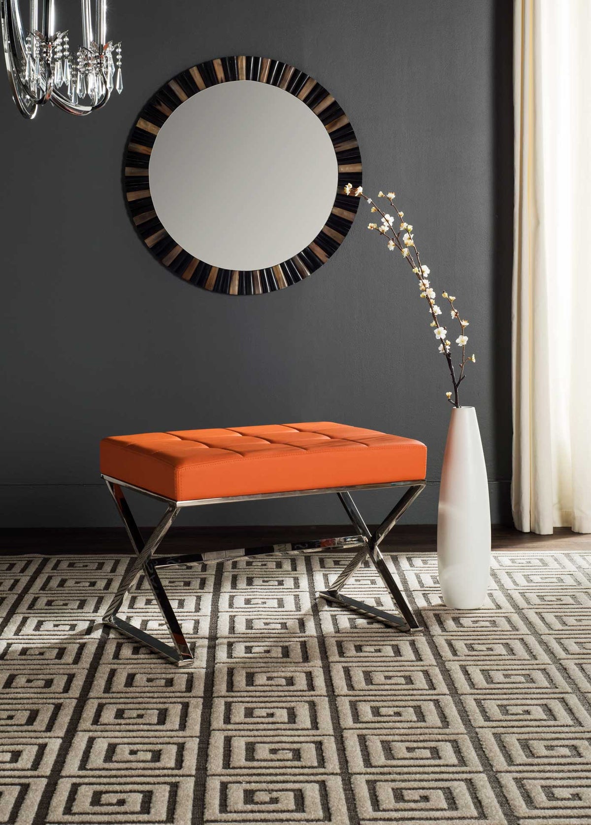 A pop of orange and crossed steel legs make this ottoman a lively seating accent.