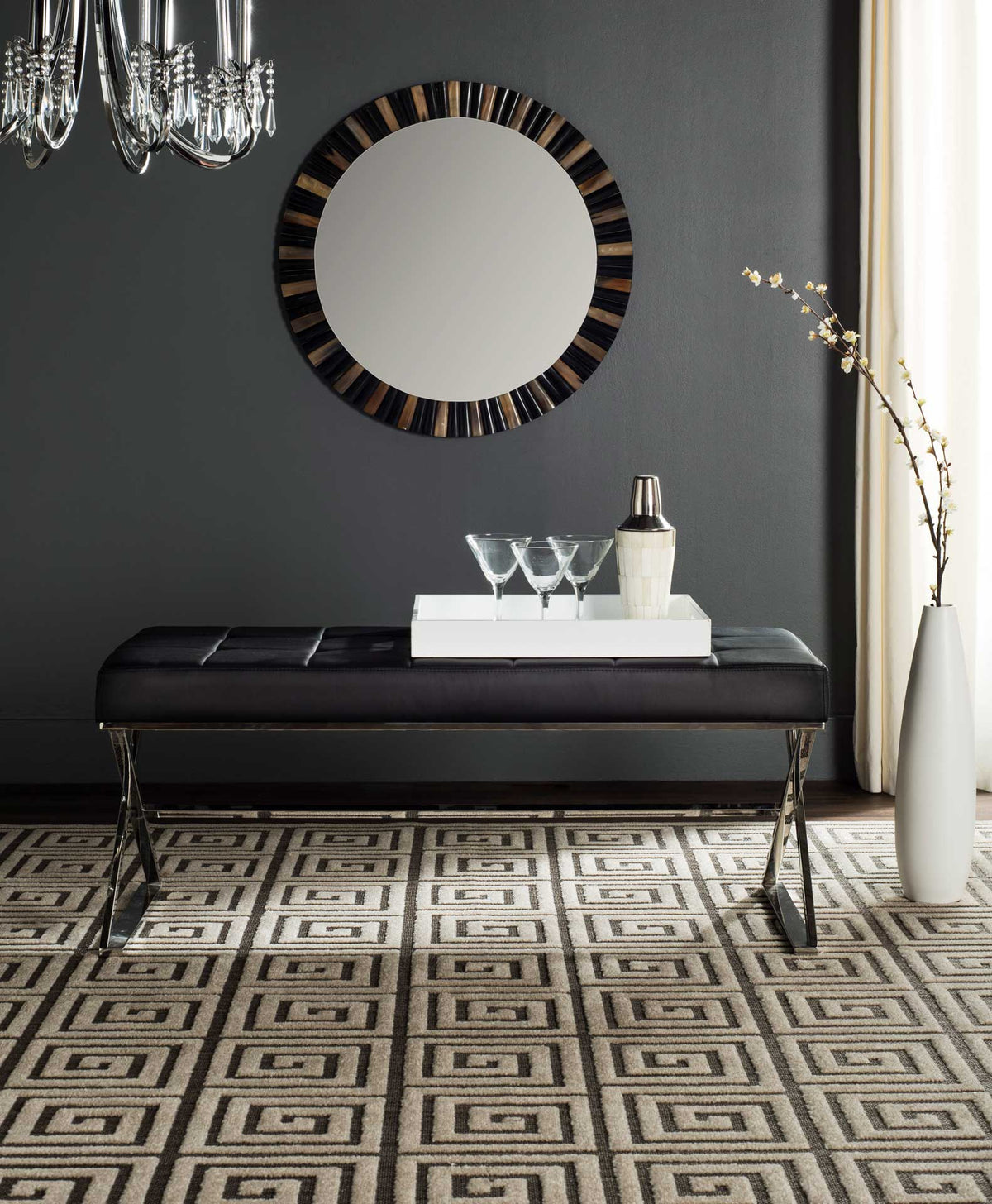 A black tufted bench on reflective X-shaped legs adds a sleek accent to a modern space.