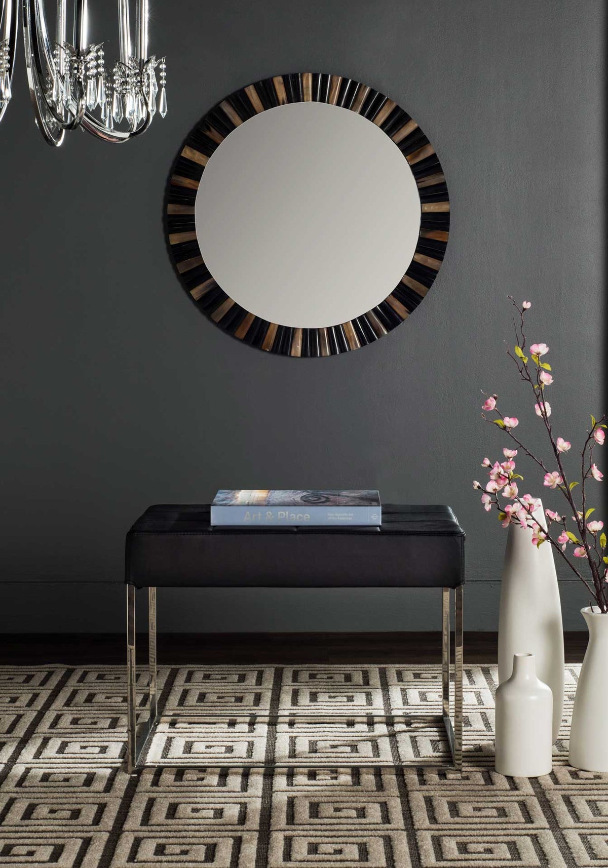 Modern black ottoman with a cushioned seat and gleaming geometric frame