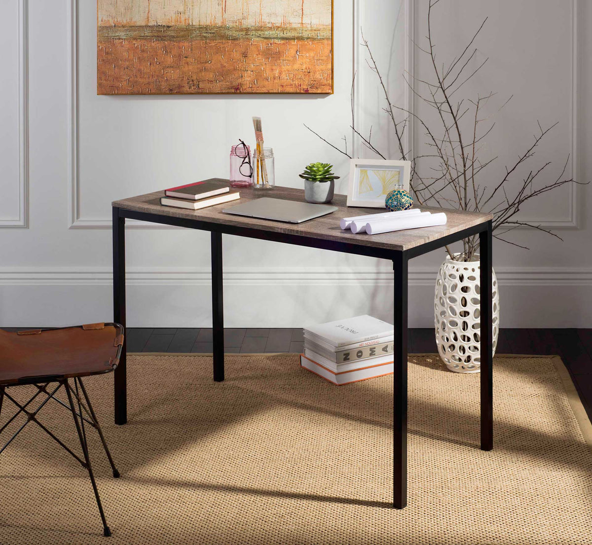A wood-grain writing surface and open black frame create an inviting home workspace.