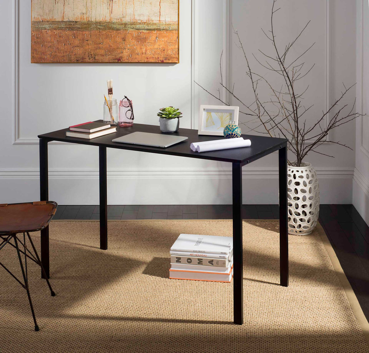 The black writing desk has room for a laptop, papers, and tabletop accessories