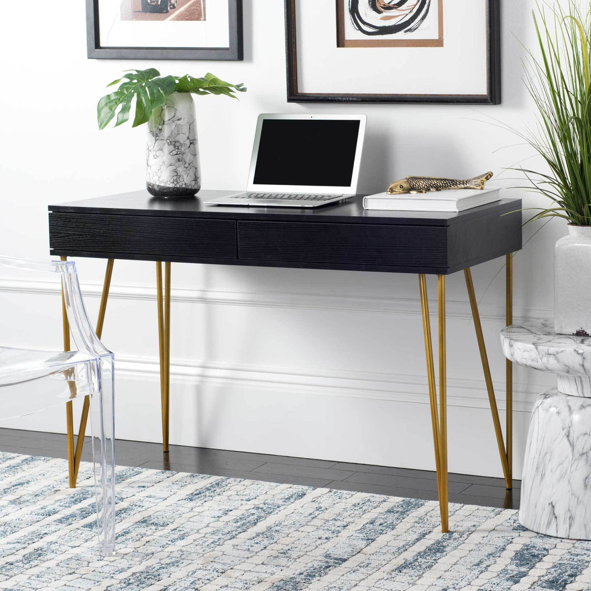 Black two-drawer desk brings sleek storage and gold legs to a modern workspace