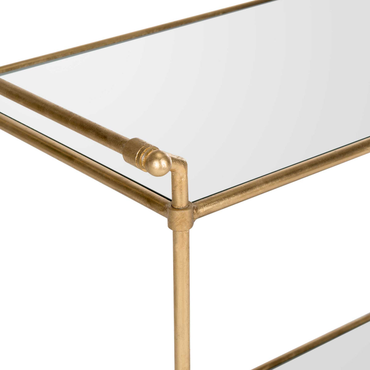 A gold handle with a ball finial accents the reflective glass top
