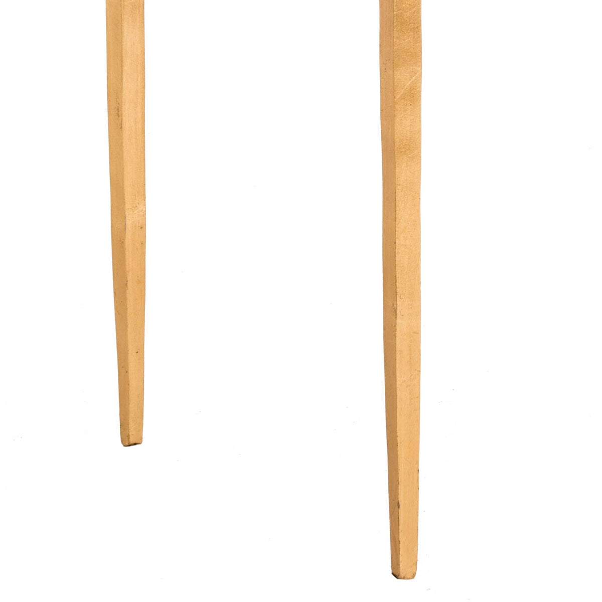 Slender antique gold legs taper to narrow feet for a light, elegant profile