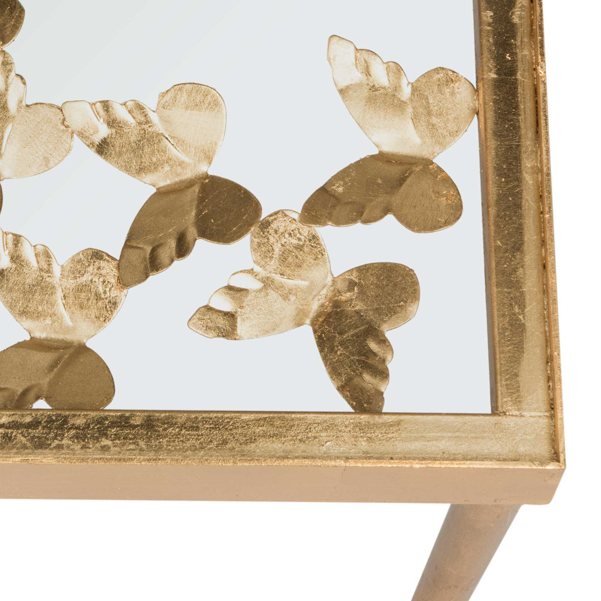 Textured gold butterflies bring intricate detail to the console's softly aged metal frame.