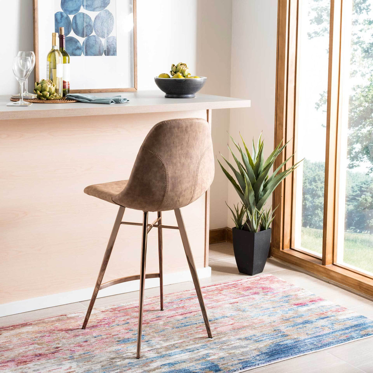 Tailored stitching traces the brown faux leather back above a slender copper-toned base.