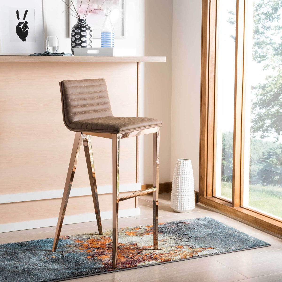 Brown tufted bar stool with lustrous copper-finished legs complements a modern home bar