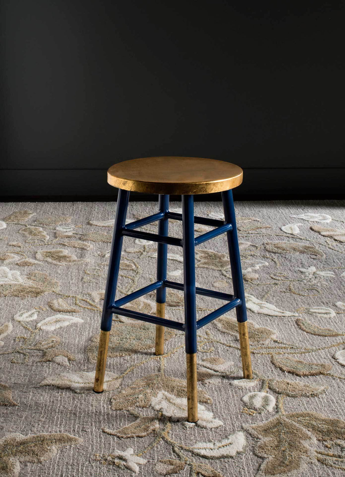 Navy and gold counter stool combines a metallic seat with slim legs and an open frame