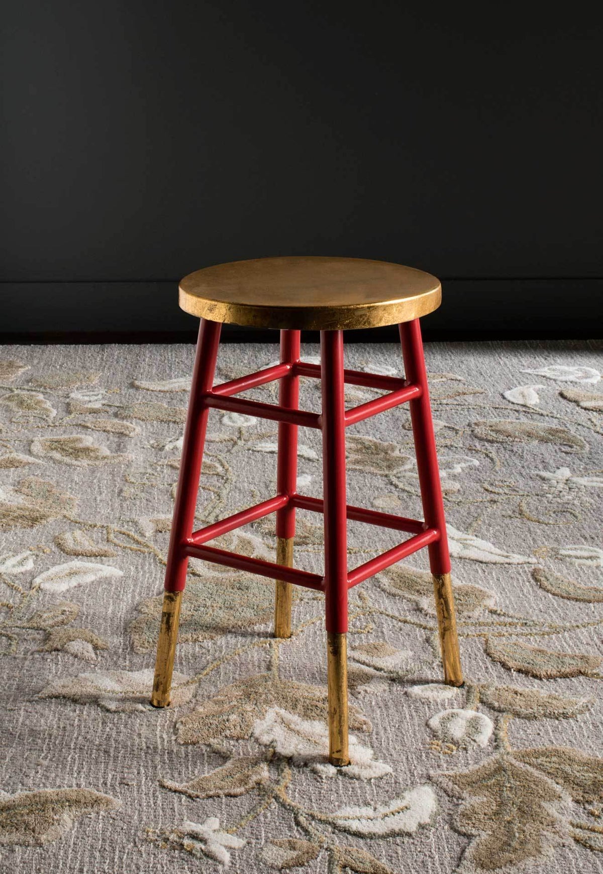 Red and gold counter stool offers a vibrant frame, metallic seat, and open square footrest