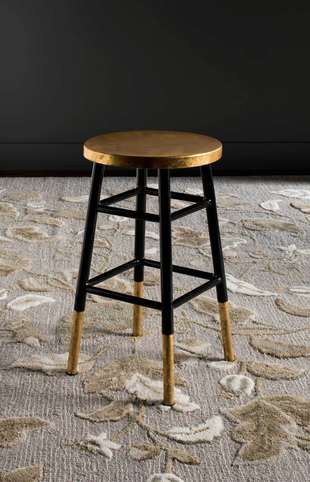 Black and gold counter stool pairs a gleaming round seat with an open iron frame
