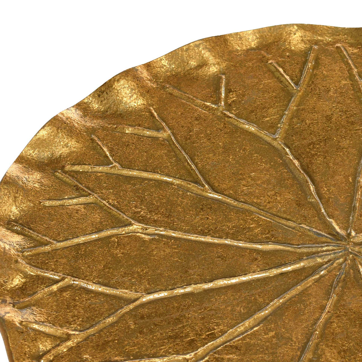 Raised leaf veins bring depth and texture to the tabletop's warm gold finish