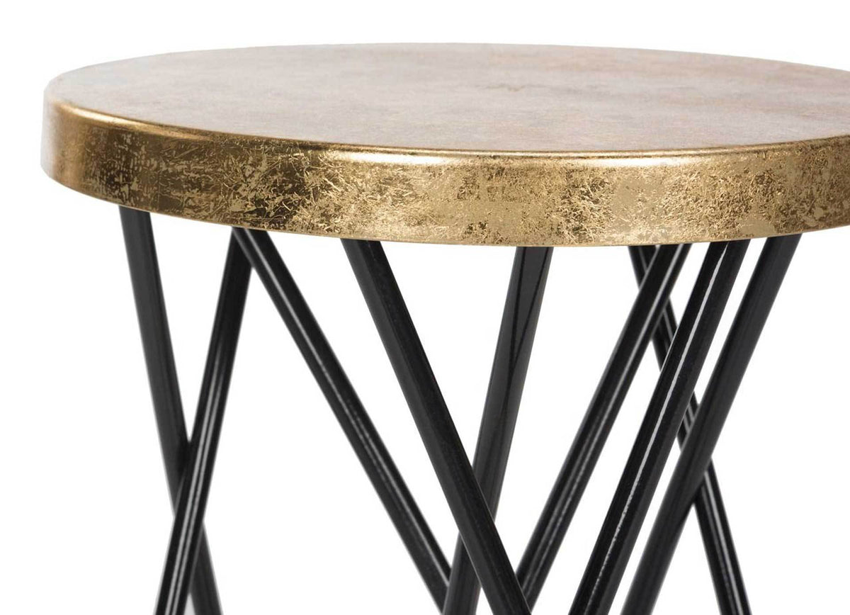 A textured gold-leaf seat rim crowns slender, intersecting black iron supports.