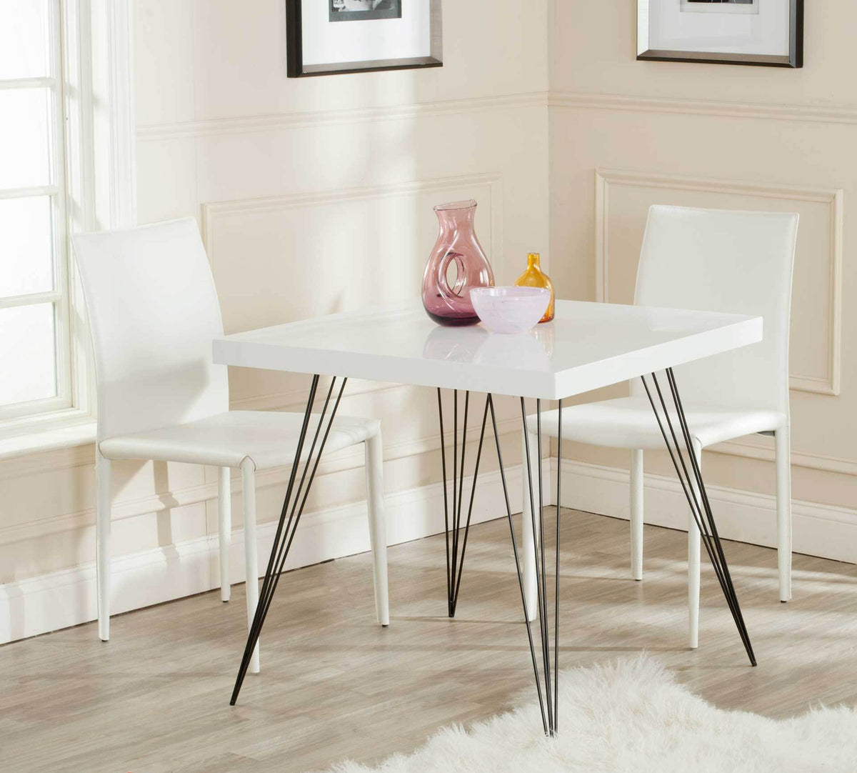 White square table with slender black legs brings an airy feel to a dining nook